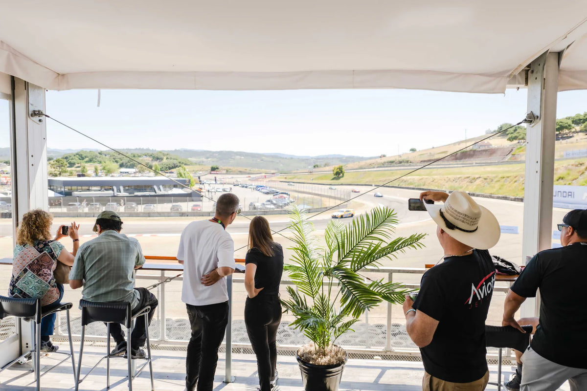 Guests watching the track from a trackside hospitality terrace