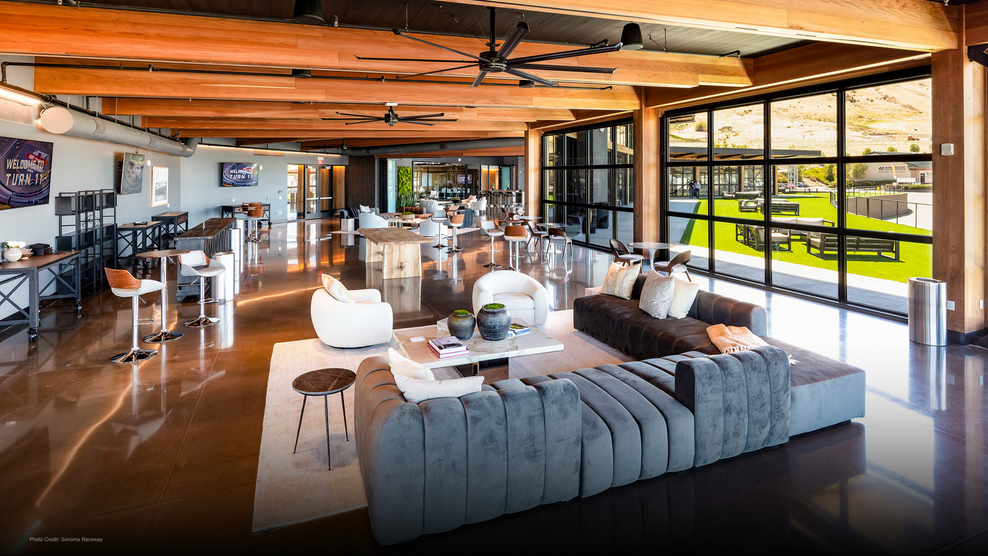 Trackside event lounge with sofas and floor-to-ceiling windows